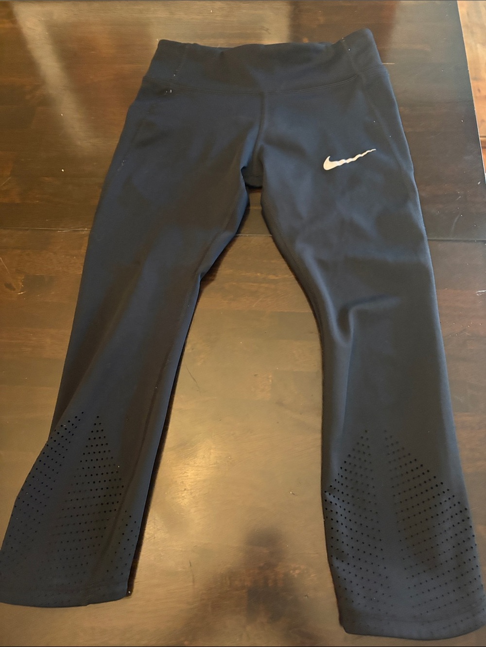 Nike women’s Black Cropped Performance Leggings with Perforated Hem